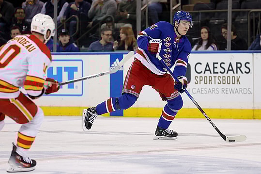 New York Rangers right wing Kaapo Kakko (24) skates with the puck against Calgary Flames center Jonathan Huberdeau (10) during the third period at Madison Square Garden