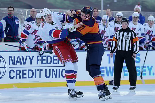 New York Rangers center Matt Rempe (73) and New York Islanders left wing Matt Martin (17) fight during the first period of a Stadium Series ice hockey game at MetLife Stadium