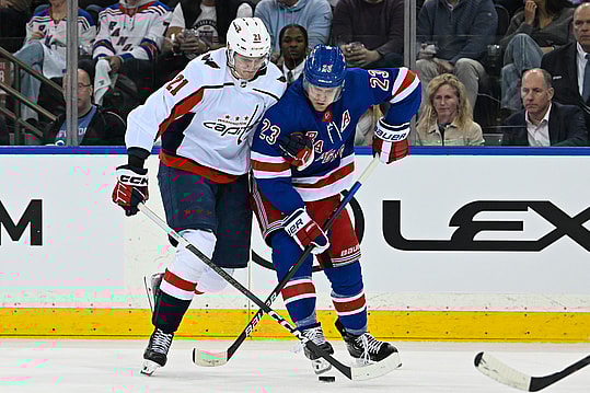 Apr 23, 2024; New York, New York, USA;  Washington Capitals center Aliaksei Protas (21) and New York Rangers defenseman Adam Fox (23) battle for the puck during the second period in game two of the first round of the 2024 Stanley Cup Playoffs at Madison Square Garden. Mandatory Credit: Dennis Schneidler-USA TODAY Sports