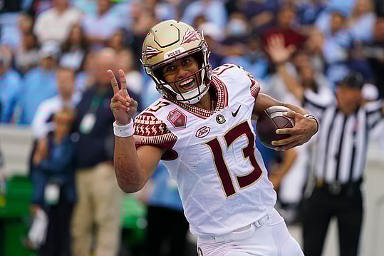 Oct 9, 2021; Chapel Hill, North Carolina, USA; Florida State Seminoles quarterback Jordan Travis (13) runs for a touchdown against the North Carolina Tar Heels during the first half at Kenan Memorial Stadium. Mandatory Credit: James Guillory-USA TODAY Sports