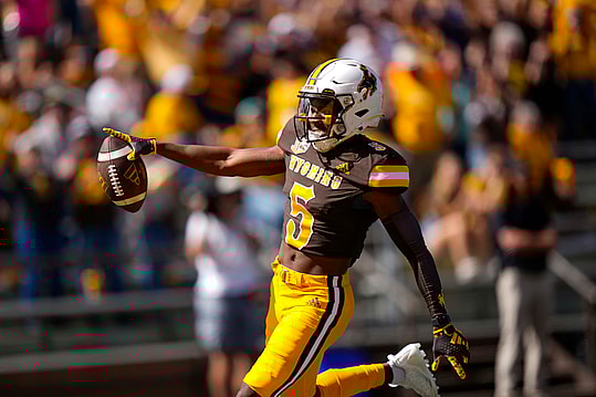 Sep 9, 2023; Laramie, Wyoming, USA; Wyoming Cowboys wide receiver Ayir Asante (5) scores a touchdown against the Portland State Vikings during the second quarter at Jonah Field at War Memorial Stadium. Mandatory Credit: Troy Babbitt-USA TODAY Sports