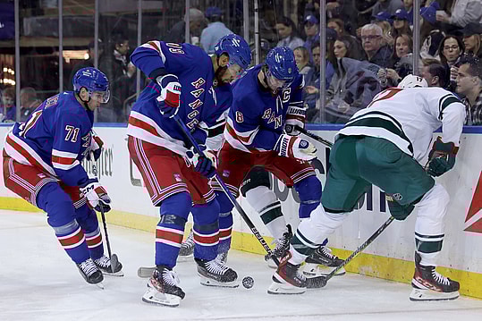 Nov 9, 2023; New York, New York, USA; Minnesota Wild left wing Marcus Foligno (17) fights for the puck against New York Rangers defensemen Jacob Trouba (8) and K'Andre Miller (79) and center Tyler Pitlick (71) during the third period at Madison Square Garden. Mandatory Credit: Brad Penner-USA TODAY Sports