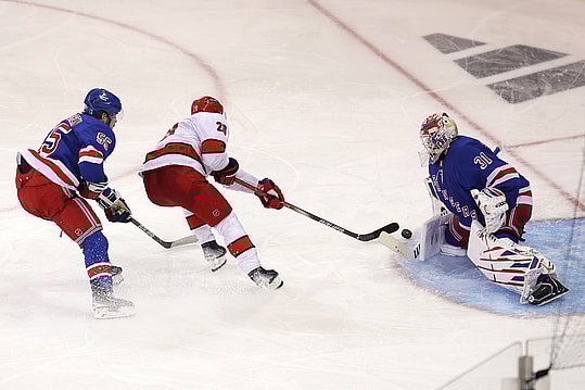 May 7, 2024; New York, New York, USA; Carolina Hurricanes center Sebastian Aho (20) takes a shot against New York Rangers goaltender Igor Shesterkin (31) in front of Rangers defenseman Ryan Lindgren (55) during the first overtime of game two of the second round of the 2024 Stanley Cup Playoffs at Madison Square Garden. Mandatory Credit: Brad Penner-USA TODAY Sports