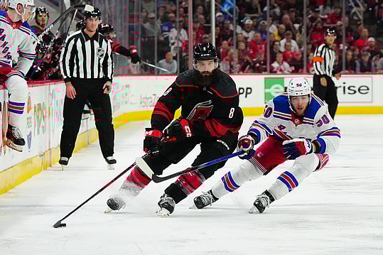 May 11, 2024; Raleigh, North Carolina, USA; Carolina Hurricanes defenseman Brent Burns (8) skates with the puck against New York Rangers left wing Will Cuylle (50) during the third period in game four of the second round of the 2024 Stanley Cup Playoffs at PNC Arena. Mandatory Credit: James Guillory-USA TODAY Sports