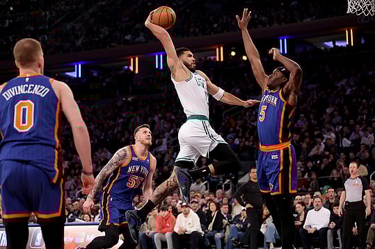 Feb 24, 2024; New York, New York, USA; Boston Celtics forward Jayson Tatum (0) drives to the basket against New York Knicks forward Precious Achiuwa (5) and center Isaiah Hartenstein (55) and guard Donte DiVincenzo (0) during the first quarter at Madison Square Garden. Mandatory Credit: Brad Penner-USA TODAY Sports