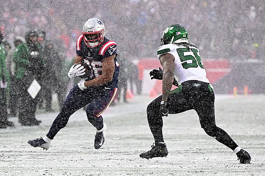 Jan 7, 2024; Foxborough, Massachusetts, USA; New England Patriots running back Kevin Harris (36) rushes against New York Jets linebacker Quincy Williams (56) during the first half at Gillette Stadium. Mandatory Credit: Brian Fluharty-USA TODAY Sports