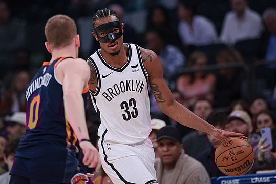 Apr 12, 2024; New York, New York, USA; Brooklyn Nets center Nic Claxton (33) dribbles against New York Knicks guard Donte DiVincenzo (0) during the first quarter at Madison Square Garden. Mandatory Credit: Vincent Carchietta-USA TODAY Sports
