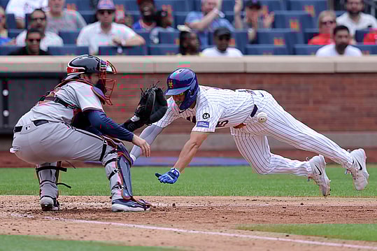 Jul 28, 2024; New York City, New York, USA; Atlanta Braves catcher Travis d'Arnaud (16) waits for the ball before tagging out New York Mets center fielder Tyrone Taylor (15) trying to score from second base on a single by New York Mets left fielder Ben Gamel (not pictured) during the fifth inning at Citi Field. Mandatory Credit: Brad Penner-USA TODAY Sports