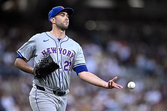 Aug 24, 2024; San Diego, California, USA; New York Mets starting pitcher David Peterson (23) tosses the ball to first base during the fifth inning against the San Diego Padres at Petco Park. Mandatory Credit: Orlando Ramirez-USA TODAY Sports