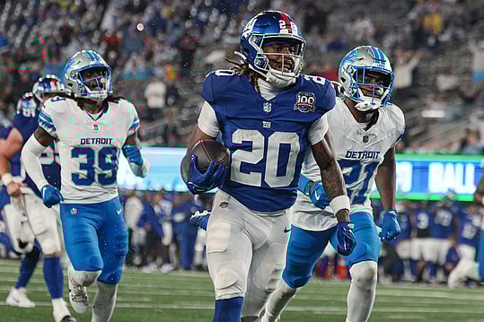 Aug 8, 2024; East Rutherford, New Jersey, USA; New York Giants running back Eric Gray (20) scores a rushing touchdown in front of Detroit Lions cornerback Amik Robertson (21) and cornerback Morice Norris (39) during the first half at MetLife Stadium. Mandatory Credit: Vincent Carchietta-USA TODAY Sports