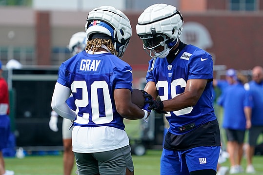 Jul 27, 2023; East Rutherford, NJ, USA; New York Giants running back Saquon Barkley (26) works with rookie running back Eric Gray (20) on day two of training camp at the Quest Diagnostics Training Facility. Mandatory Credit: Danielle Parhizkaran-USA TODAY Sports