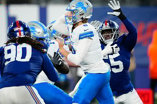 Detroit Lions quarterback Nate Sudfeld (8) gets ready to throw the ball as New York Giants linebacker Boogie Basham (55) tries to prevent the pass, Thursday, August 8 2024, in East Rutherford.