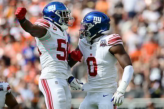 Sep 22, 2024; Cleveland, Ohio, USA; New York Giants linebacker Bobby Okereke (58) and linebacker Brian Burns (0) celebrate after Burns strip sacked Cleveland Browns quarterback Deshaun Watson (not pictured) during the first half at Huntington Bank Field. Mandatory Credit: Ken Blaze-Imagn Images