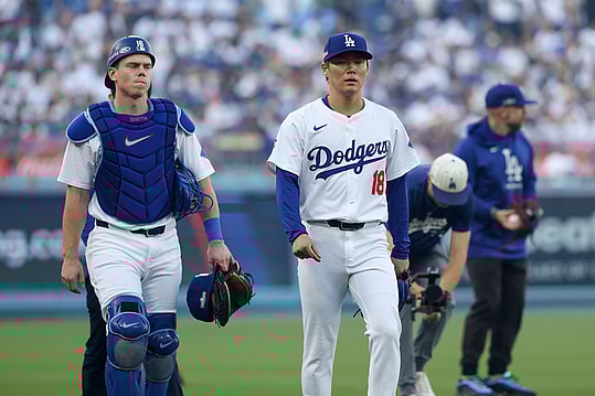 Oct 5, 2024; Los Angeles, California, USA; Los Angeles Dodgers catcher Will Smith (16) and pitcher Yoshinobu Yamamoto (18) head to the dugout before playing the San Diego Padres during game one of the NLDS for the 2024 MLB Playoffs at Dodger Stadium. Mandatory Credit: Kiyoshi Mio-Imagn Images