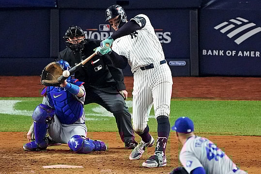Oct 30, 2024; New York, New York, USA; New York Yankees outfielder Aaron Judge (99) hits a double during the eighth inning against the Los Angeles Dodgers in game four of the 2024 MLB World Series at Yankee Stadium. Mandatory Credit: Robert Deutsch-Imagn Images
