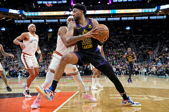 Dec 15, 2023; San Antonio, Texas, USA; Los Angeles Lakers forward Christian Wood (35) drives to the basket while defended by San Antonio Spurs guard Malaki Branham (22) during the second half at Frost Bank Center. Mandatory Credit: Scott Wachter-Imagn Images