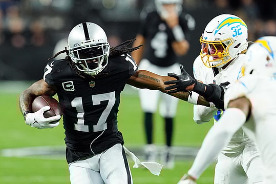 Dec 14, 2023; Paradise, Nevada, USA; Las Vegas Raiders wide receiver Davante Adams (17) runs against Los Angeles Chargers safety Alohi Gilman (32) in the first quarter at Allegiant Stadium. Mandatory Credit: Stephen R. Sylvanie-Imagn Images