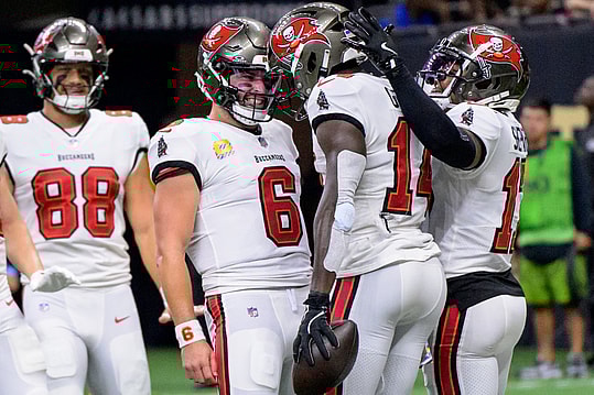 Oct 13, 2024; New Orleans, Louisiana, USA; Tampa Bay Buccaneers quarterback Baker Mayfield (6) celebrates the touchdown reception of Tampa Bay Buccaneers wide receiver Chris Godwin (14) during the first quarter against the New Orleans Saints at Caesars Superdome. Mandatory Credit: Matthew Hinton-Imagn Images