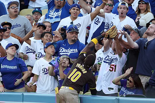 Oct 6, 2024; Los Angeles, California, USA; San Diego Padres outfielder Jurickson Profar (10) catches a ball hit by Los Angeles Dodgers shortstop Mookie Betts (50) in the first inning during game two of the NLDS for the 2024 MLB Playoffs at Dodger Stadium. Mandatory Credit: Kiyoshi Mio-Imagn Images