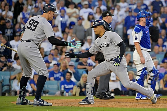 Oct 26, 2024; Los Angeles, California, USA; New York Yankees outfielder Juan Soto (22) celebrates with outfielder Aaron Judge (99) after hitting a solo home run in the third inning against the Los Angeles Dodgers during game two of the 2024 MLB World Series at Dodger Stadium. Mandatory Credit: Jayne Kamin-Oncea-Imagn Images