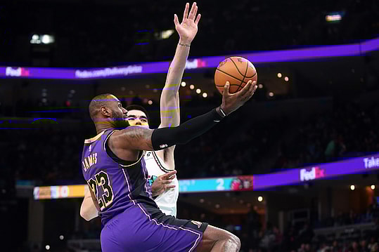 Nov 6, 2024; Memphis, Tennessee, USA; Los Angeles Lakers forward LeBron James (23 drives to the basket as Memphis Grizzlies center Zach Edey (14) defends during the first half at FedExForum. Mandatory Credit: Petre Thomas-Imagn Images