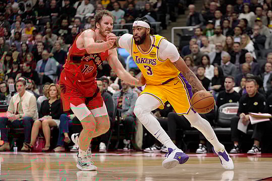 Nov 1, 2024; Toronto, Ontario, CAN; Los Angeles Lakers forward Anthony Davis (3) drives to the net past Toronto Raptors center Jakob Poeltl (19) during the first half at Scotiabank Arena. Mandatory Credit: John E. Sokolowski-Imagn Images