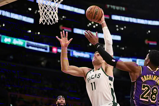 Mar 8, 2024; Los Angeles, California, USA;  Milwaukee Bucks center Brook Lopez (11) dunks the ball against Los Angeles Lakers forward Rui Hachimura (28) during the first quarter at Crypto.com Arena. Mandatory Credit: Kiyoshi Mio-Imagn Images