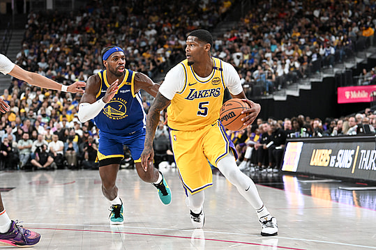 Oct 15, 2024; Las Vegas, Nevada, USA; Los Angeles Lakers forward Cam Reddish (5) drives past Golden State Warriors guard Buddy Hield (7) in the third quarter during a preseason game at T-Mobile Arena. Mandatory Credit: Candice Ward-Imagn Images