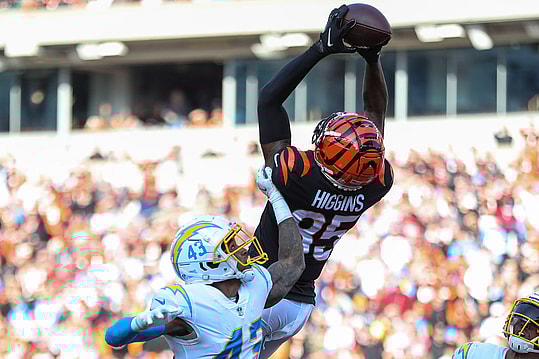 Dec 5, 2021; Cincinnati, Ohio, USA; Cincinnati Bengals wide receiver Tee Higgins (85) catches a pass in the end zone against Los Angeles Chargers cornerback Michael Davis (43) in the first half at Paul Brown Stadium. Mandatory Credit: Katie Stratman-Imagn Images