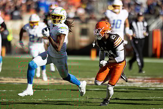 Nov 3, 2024; Cleveland, Ohio, USA; Los Angeles Chargers wide receiver Quentin Johnston (1) runs the ball as Cleveland Browns cornerback Denzel Ward (21) chases him during the second quarter at Huntington Bank Field. Mandatory Credit: Scott Galvin-Imagn Images