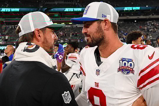 Aug 24, 2024; East Rutherford, New Jersey, USA; New York Jets quarterback Aaron Rodgers (left) and New York Giants quarterback Daniel Jones (right) meet following the game at MetLife Stadium. Mandatory Credit: Rich Barnes-Imagn Images