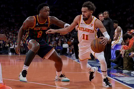 Dec 11, 2024; New York, New York, USA; Atlanta Hawks guard Trae Young (11) controls the ball against New York Knicks forward OG Anunoby (8) during the second quarter at Madison Square Garden. Mandatory Credit: Brad Penner-Imagn Images
