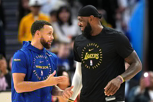 Dec 25, 2024; San Francisco, California, USA; Golden State Warriors guard Stephen Curry (left) and Los Angeles Lakers forward LeBron James (right) talk before the game at Chase Center. Mandatory Credit: Darren Yamashita-Imagn Images