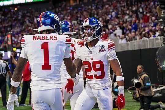 Dec 22, 2024; Atlanta, Georgia, USA; New York Giants running back Tyrone Tracy Jr. (29) reacts with wide receiver Malik Nabers (1) after catching a touchdown pass against the Atlanta Falcons during the first half at Mercedes-Benz Stadium. Mandatory Credit: Dale Zanine-Imagn Images