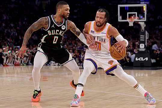 Jan 12, 2025; New York, New York, USA; New York Knicks guard Jalen Brunson (11) controls the ball against Milwaukee Bucks guard Damian Lillard (0) during the first quarter at Madison Square Garden. Mandatory Credit: Brad Penner-Imagn Images