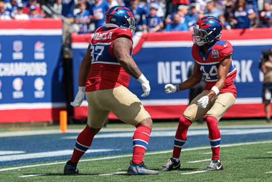 Sep 8, 2024; East Rutherford, New Jersey, USA; New York Giants defensive tackle Dexter Lawrence II (97) celebrates his sack with cornerback Nick McCloud (44) during the first quarter against the Minnesota Vikings at MetLife Stadium. Mandatory Credit: Vincent Carchietta-Imagn Images
