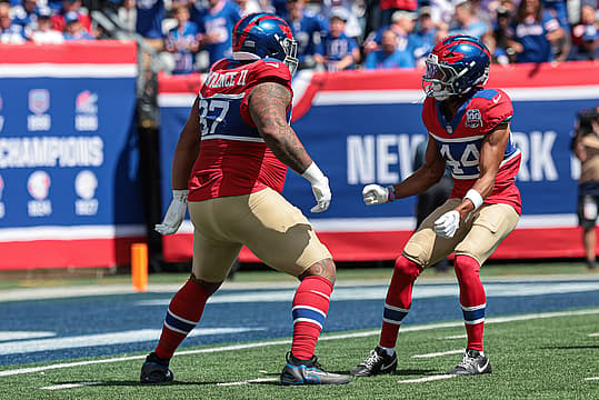 Sep 8, 2024; East Rutherford, New Jersey, USA; New York Giants defensive tackle Dexter Lawrence II (97) celebrates his sack with cornerback Nick McCloud (44) during the first quarter against the Minnesota Vikings at MetLife Stadium. Mandatory Credit: Vincent Carchietta-Imagn Images