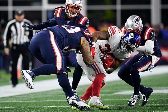 Oct 10, 2019; Foxborough, MA, USA; New England Patriots free safety Devin McCourty (32) and defensive tackle Lawrence Guy (93) tackle New York Giants running back Elijhaa Penny (39) during the second half at Gillette Stadium. Mandatory Credit: Bob DeChiara-USA TODAY Sports