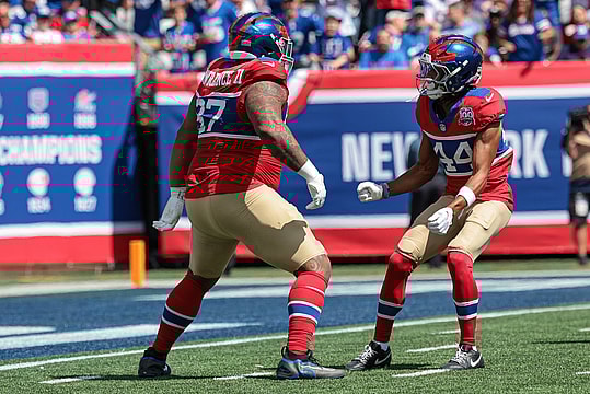 Sep 8, 2024; East Rutherford, New Jersey, USA; New York Giants defensive tackle Dexter Lawrence II (97) celebrates his sack with cornerback Nick McCloud (44) during the first quarter against the Minnesota Vikings at MetLife Stadium. Mandatory Credit: Vincent Carchietta-Imagn Images