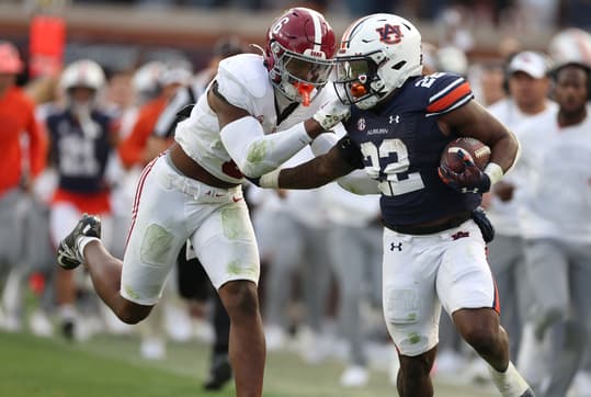Nov 25, 2023; Auburn, Alabama, USA; Alabama Crimson Tide defensive back Jaylen Key (6) grabs the face mask of Auburn Tigers running back Damari Alston (22) during the second quarter at Jordan-Hare Stadium. Mandatory Credit: John Reed-USA TODAY Sports