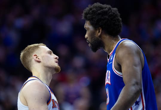Apr 25, 2024; Philadelphia, Pennsylvania, USA; Philadelphia 76ers center Joel Embiid (21) has words with New York Knicks guard Donte DiVincenzo (L) after a play during the first quarter of game three of the first round for the 2024 NBA playoffs at Wells Fargo Center. Mandatory Credit: Bill Streicher-USA TODAY Sports