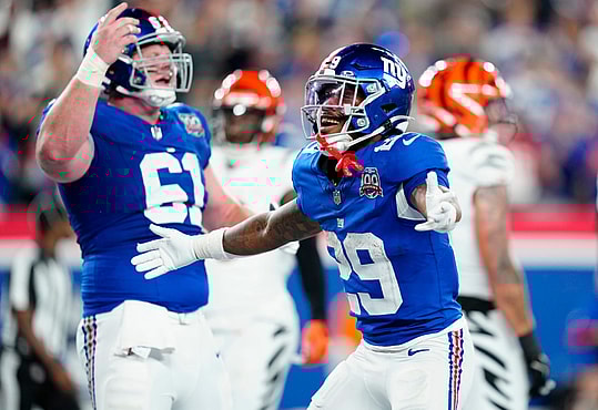 New York Giants running back Tyrone Tracy Jr. (29) celebrates his third quarter touchdown beside teammate New York Giants center John Michael Schmitz Jr. (61), Sunday, October 13, 2024, in East Rutherford.