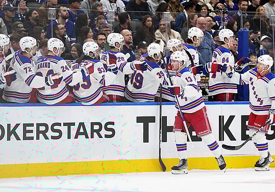 Oct 19, 2024; Toronto, Ontario, CAN; New York Rangers left wing Alexis Lafreniere (13) celebrates at the bench after scoring a goal against the Toronto Maple Leafs during the first period at Scotiabank Arena. Mandatory Credit: Nick Turchiaro-Imagn Images