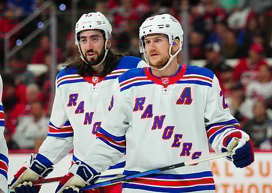 May 11, 2024; Raleigh, North Carolina, USA; New York Rangers defenseman Adam Fox (23) and center Mika Zibanejad (93) look on against the Carolina Hurricanes during the first period in game four of the second round of the 2024 Stanley Cup Playoffs at PNC Arena. Mandatory Credit: James Guillory-USA TODAY Sports