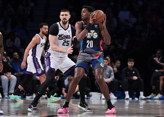 Apr 7, 2024; Brooklyn, New York, USA; Brooklyn Nets center Day'Ron Sharpe (20) looks to pass as Sacramento Kings center Alex Len (25) defends during the first half at Barclays Center. Mandatory Credit: Vincent Carchietta-Imagn Images