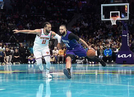 Nov 29, 2024; Charlotte, North Carolina, USA; Charlotte Hornets forward Cody Martin (11) drives past New York Knicks guard Jalen Brunson (11) during the second half at the Spectrum Center. Mandatory Credit: Sam Sharpe-Imagn Images