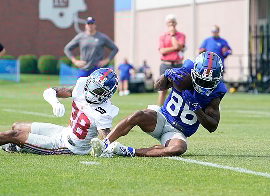 Jul 27, 2023; East Rutherford, NJ, USA;  New York Giants wide receiver Jaydon Mickens (88) makes a catch over cornerback Cor'Dale Flott (28) on day two of training camp at the Quest Diagnostics Training Facility. Mandatory Credit: Danielle Parhizkaran-USA TODAY Sports