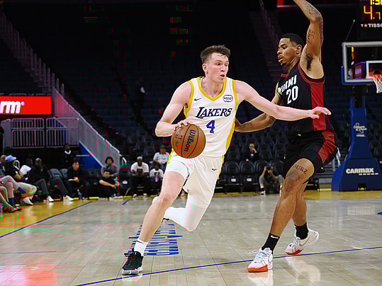 Jul 10, 2024; San Francisco, CA, USA; Los Angeles Lakers guard Dalton Knecht (4) drives against Miami Heat forward Keshad Johnson (20) during the third quarter at Chase Center. Mandatory Credit: Kelley L Cox-Imagn Images