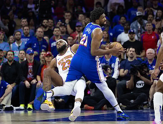 May 2, 2024; Philadelphia, Pennsylvania, USA; Philadelphia 76ers center Joel Embiid (21) is fouled by New York Knicks center Mitchell Robinson (23) while driving during the first half of game six of the first round for the 2024 NBA playoffs at Wells Fargo Center. Mandatory Credit: Bill Streicher-USA TODAY Sports