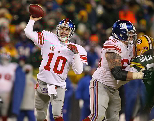 Jan 20, 2008; Green Bay, WI, USA; New York Giants quarterback Eli Manning (10) throws a pass fourth quarter against the Green Bay Packers during the NFC championship game at Lambeau Field. The Giants beat the Packers 23-20 in overtime. Mandatory Credit: Matthew Emmons-USA TODAY Sports